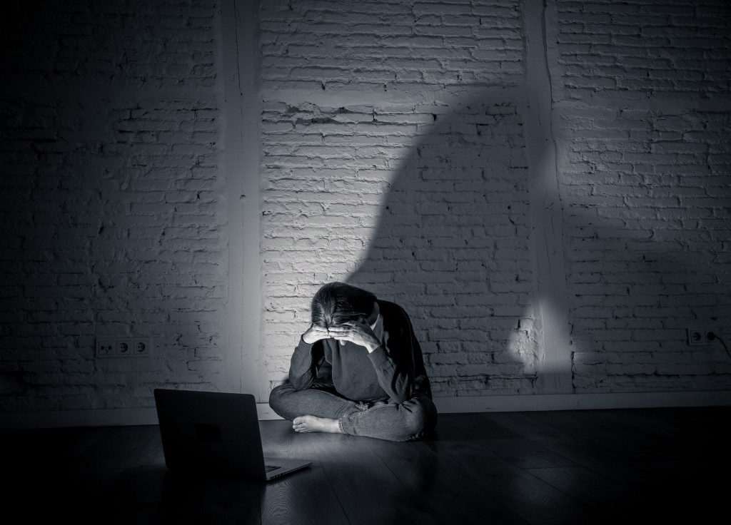 Sad and scared woman with computer laptop